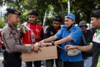 Anggota Polri memberikan air mineral dan roti kepada peserta unjuk rasa di kawasan Monas, Gambir, Rabu (10/9/2025) sore. Dok-Polri