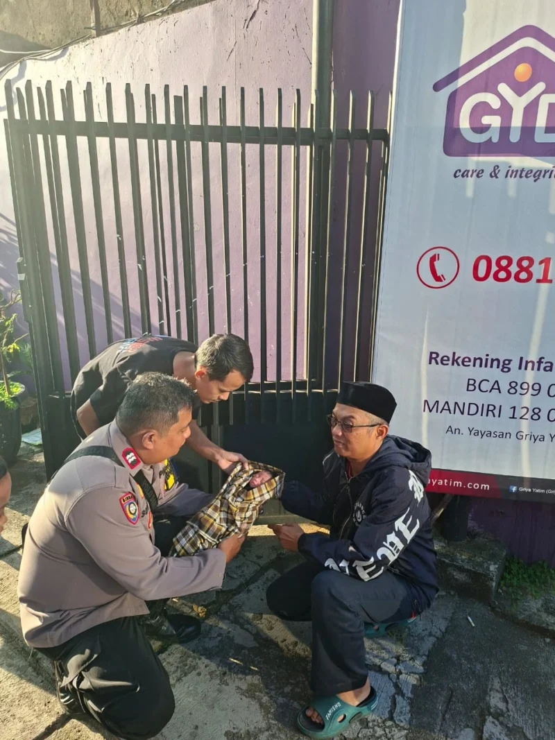 Bhabinkamtibmas Palmerah bersama warga saat mengevakuasi bayi perempuan yang ditemukan di depan Rumah Yatim Kemanggisan, Jakarta Barat. Dok-Polri