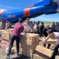 Proses penurunan bantuan bencana banjir dan longsor dari pesawat Polri di Bandara Internasional Minangkabau. (Posnews/Ist)
