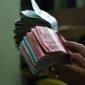 Ilustrasi, Wacana redenominasi (Rp1000 jadi Rp1) masuk PMK 2025-2029. Pengamat tegaskan ini bukan sanering (potong nilai), sementara BI, Menkeu, dan Istana sebut implementasi masih sangat jauh. Dok: Istimewa.