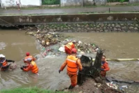Pasukan Oranye membersihkan sampah di lokasi rawan banjir Jakarta untuk antisipasi curah hujan tinggi. (Posnews/Ist)