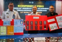 Plt Direktur Jenderal Imigrasi Yuldi Yusman menunjukkan baran bukti jaringan Love Scamming AI, 27 WN China ditangkap Imigrasi. (Posnews/Ist)