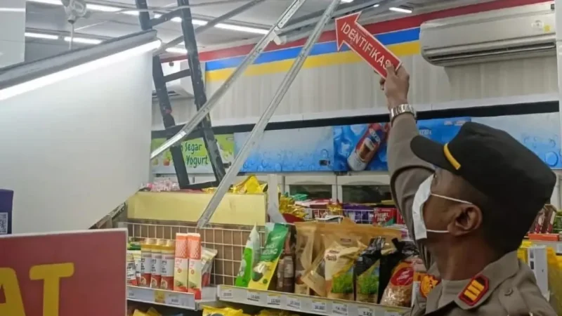 Polisi Polsek Sukmajaya melakukan olah TKP dan pemeriksaan CCTV di lokasi pembobolan minimarket Jalan Studio Alam, Depok, sementara dua mesin ATM rusak akibat aksi pencurian. (Posnews/Ist)