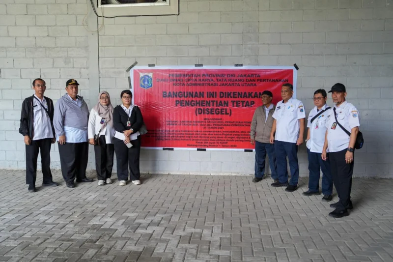 Petugas Sudin CKTRP Jakarta Utara memasang segel penghentian kegiatan pada lapangan padel di kawasan Ancol karena belum memiliki Persetujuan Bangunan Gedung (PBG). (Posnews/MR)