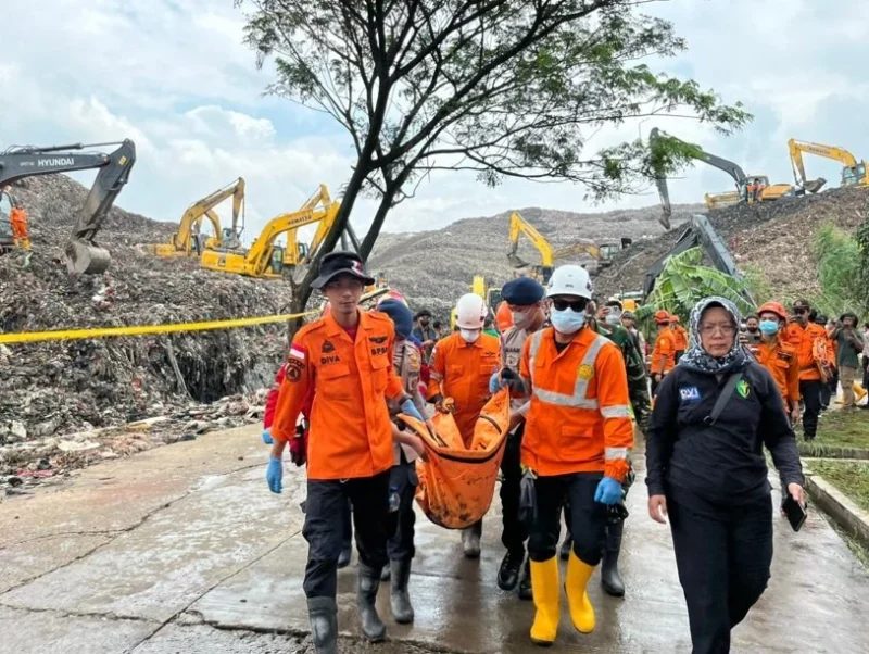 Tim SAR mengevakuasi korban longsor TPST Bantargebang Bekasi dari timbunan sampah. (Posnews/BNPB)