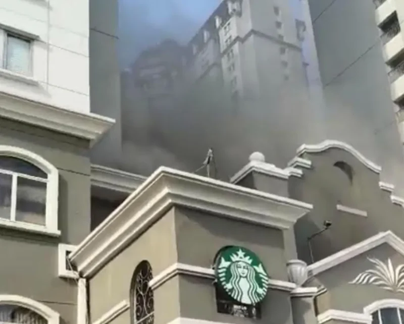 Asap tebal keluar dari lantai dua Apartemen Mediterania Tanjung Duren saat petugas Damkar melakukan pemadaman dan evakuasi penghuni. (Posnews/Ist)