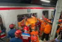 Petugas mengevakuasi korban kecelakaan kereta di Bekasi Timur dengan ambulans dan tim medis di lokasi kejadian serta suasana duka keluarga korban. (Posnews/Basarnas)
