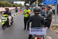 Petugas Ditlantas Polda Metro Jaya mengawasi pengendara di titik rawan pelanggaran lalu lintas. (Posnews/Humas PMJ)

